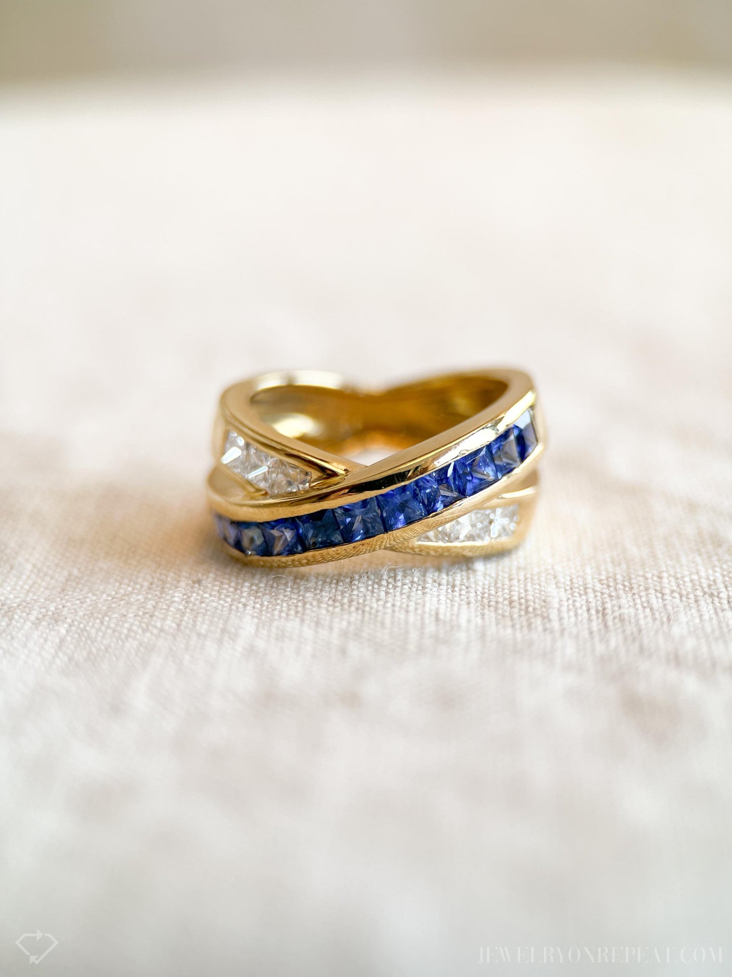 May include: A gold band ring with a row of blue sapphires and a row of clear diamonds.
