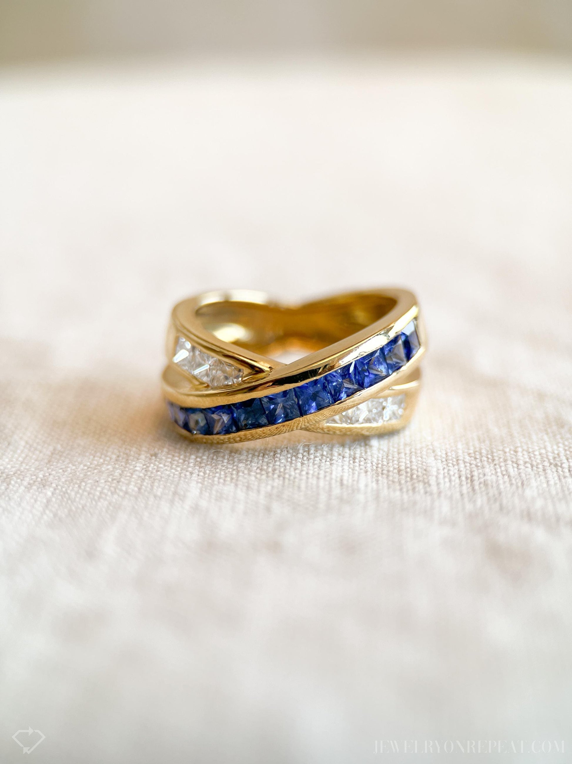 May include: A gold band ring with a row of blue sapphires and a row of clear diamonds.